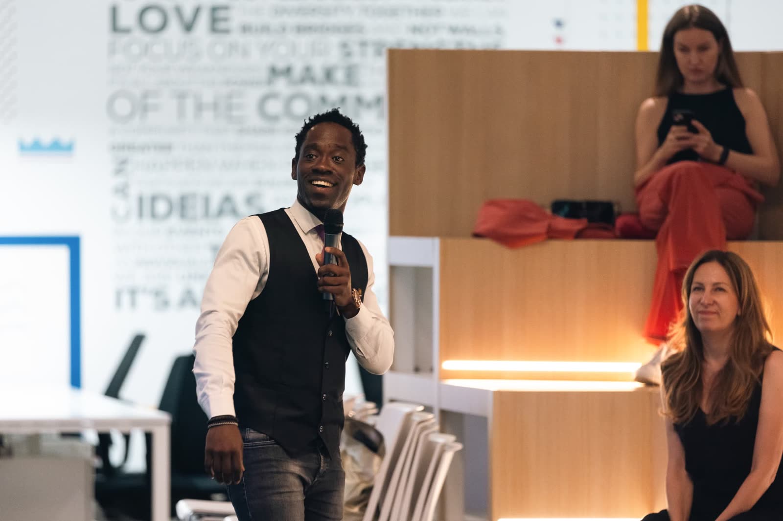 Steven Dossou speaking to a room during a personal growth session