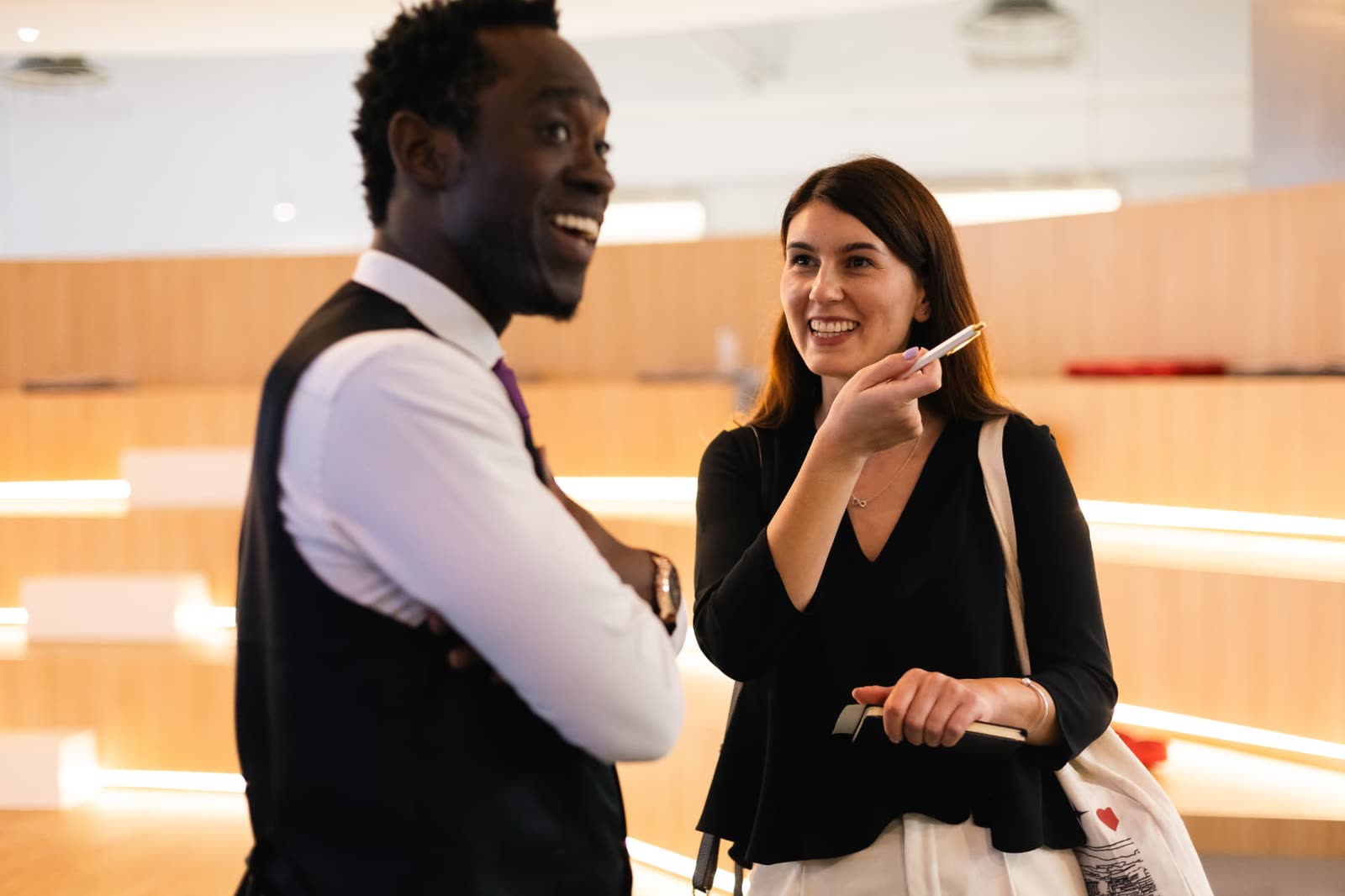 Steven Dossou advising a client one to one at a business event